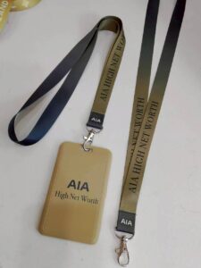 สายคล้องคอ AIA สกรีนโลโก้บนกรอบใส่บัตรสีทอง